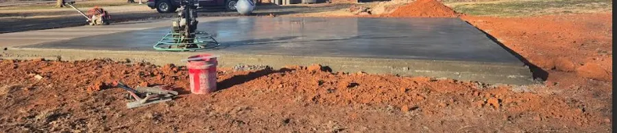 Freshly poured concrete slab with a power trowel still on it